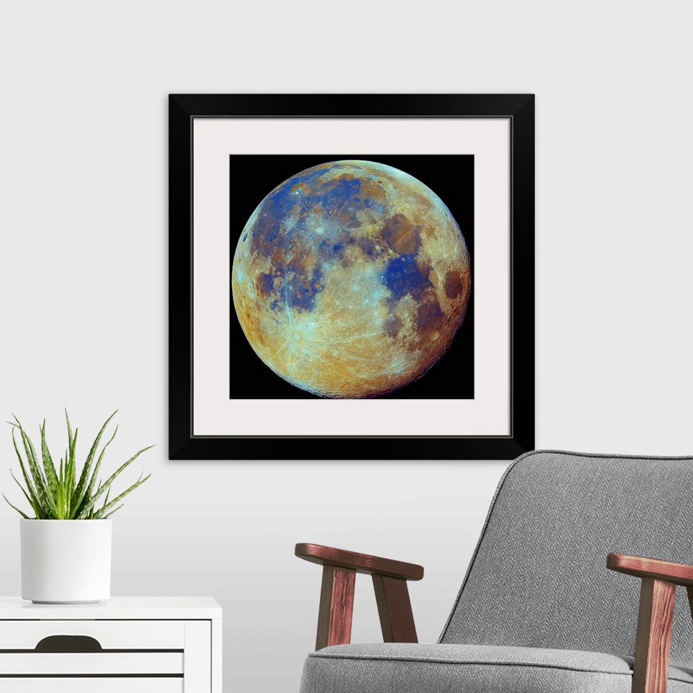 A modern room featuring Square photo on canvas of the moon highlighted in color on a dark backdrop.