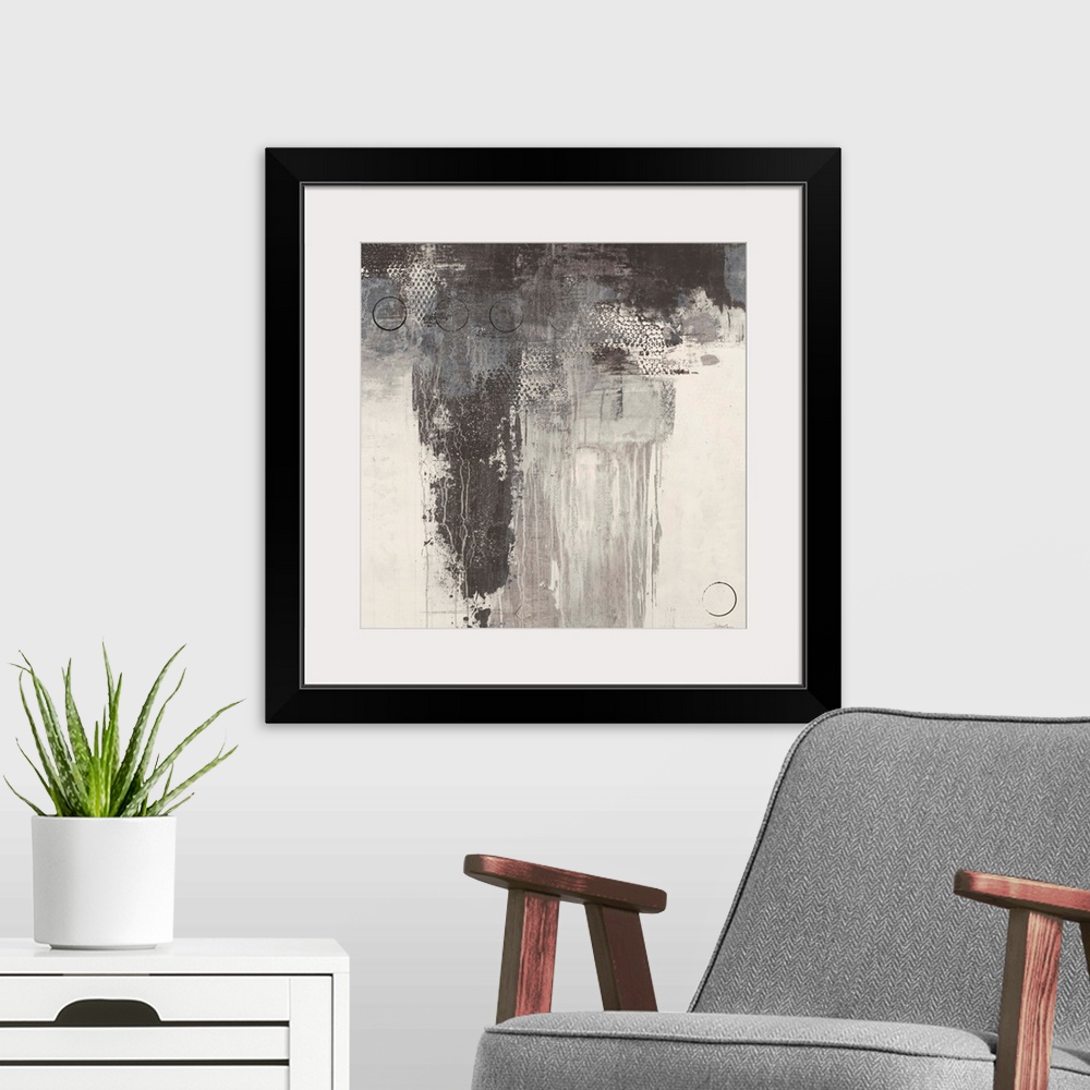 A modern room featuring A square abstract painting in varies tones of gray with thin black circles overlaying.