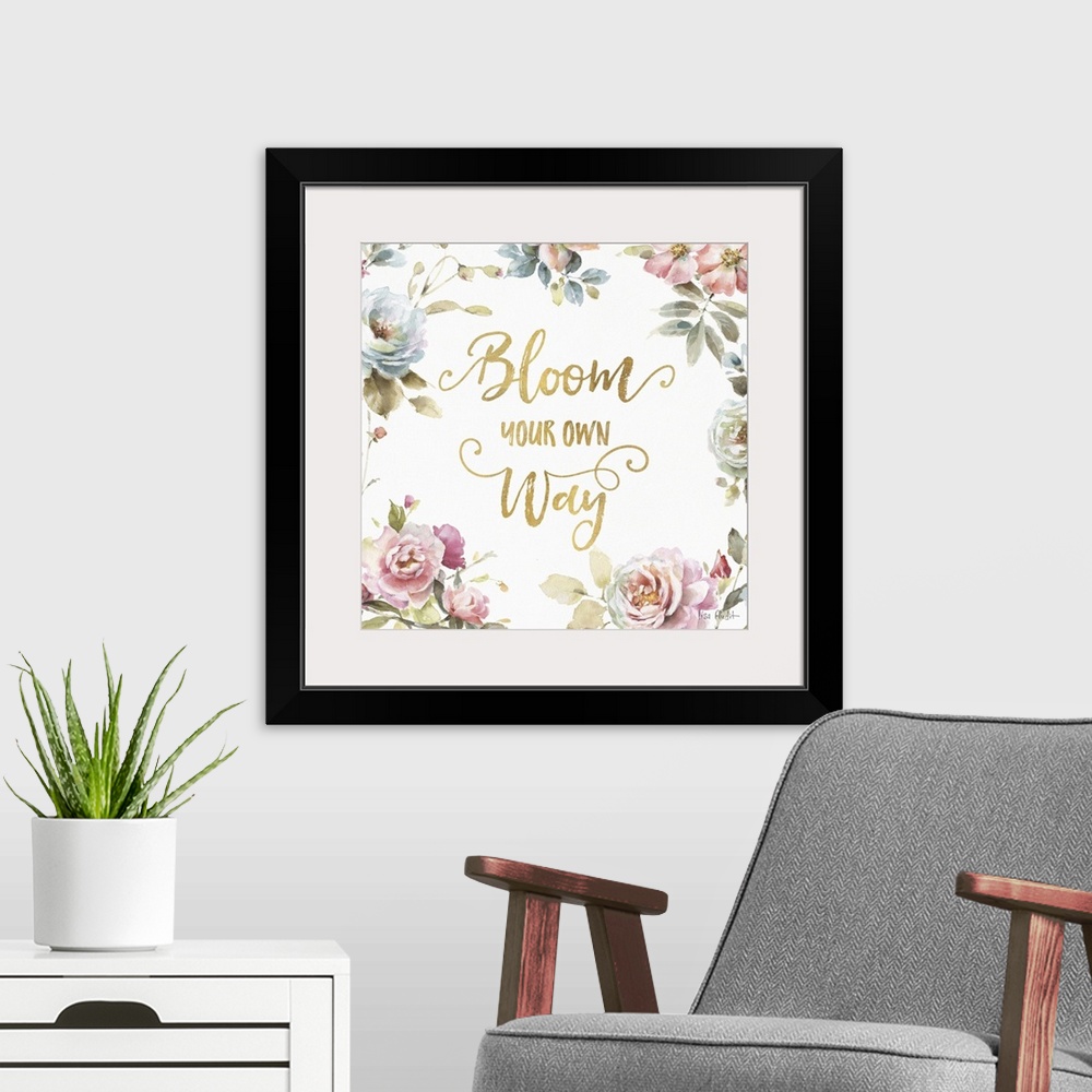 A modern room featuring "Bloom Your Own Way" written in gold and surrounded by a watercolor floral print.