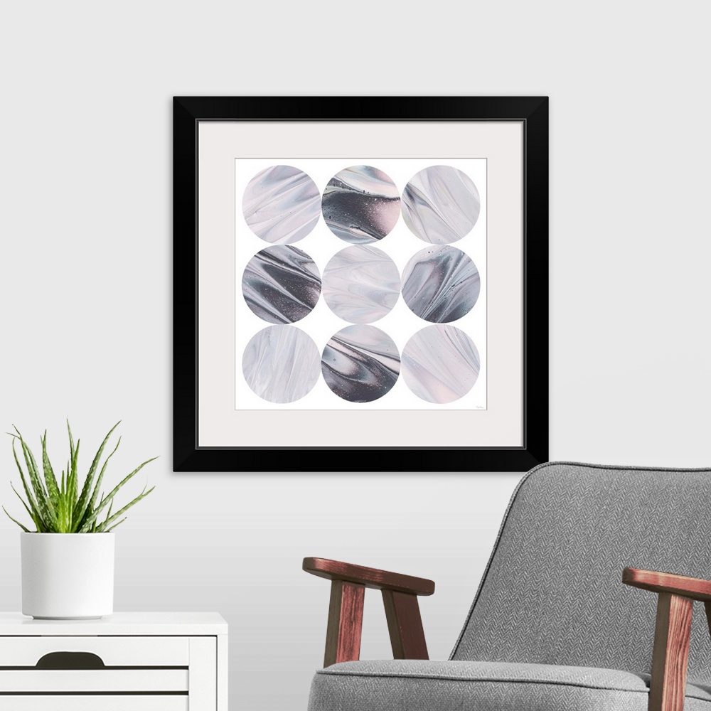 A modern room featuring Square geometric art of purple, blue, black, and pink marble designed circles stacked in rows on ...