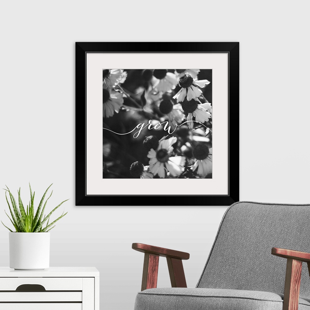 A modern room featuring Handlettering in white across a black and white photograph of flowers.