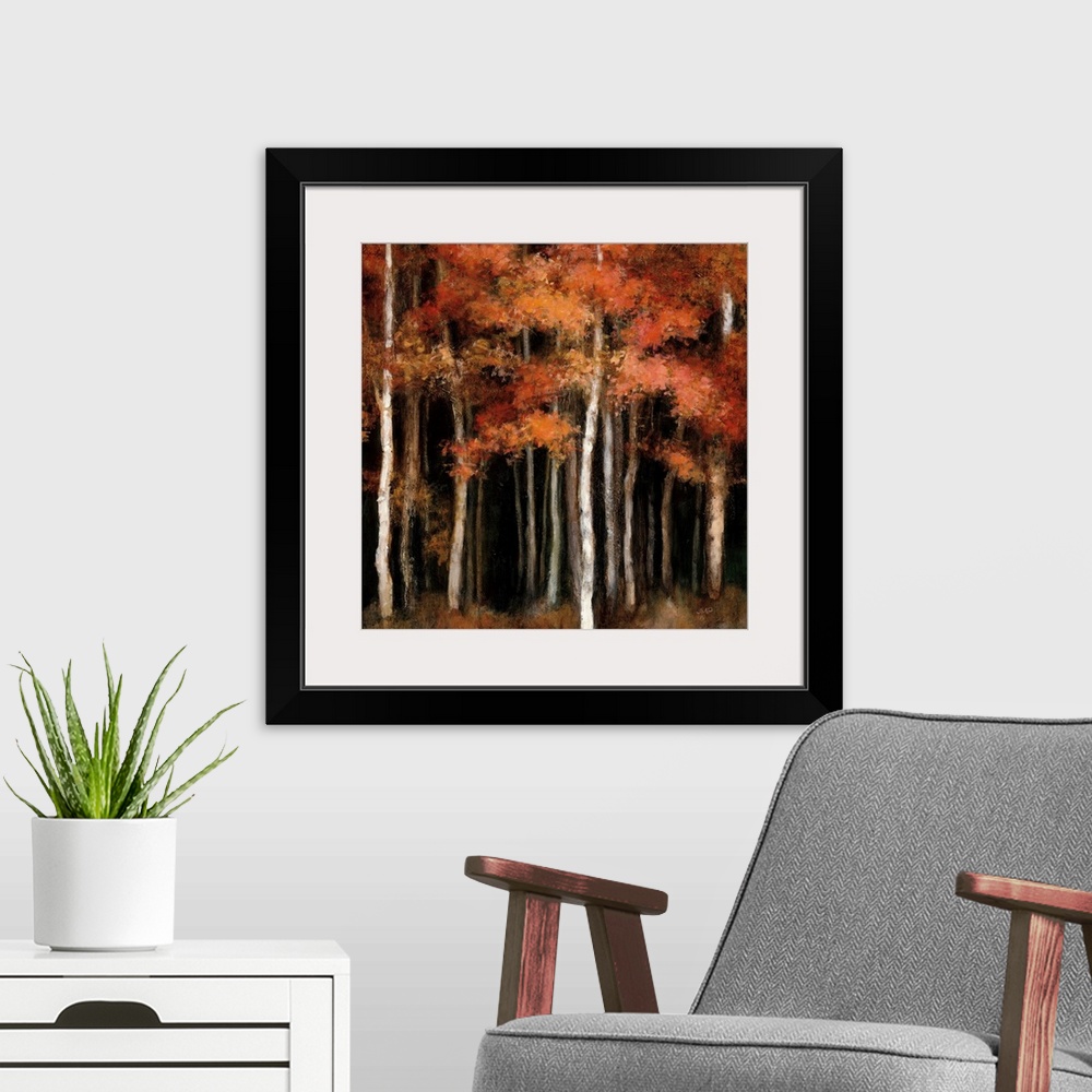 A modern room featuring Square contemporary painting of dark woods filled with orange and yellow Autumn trees.