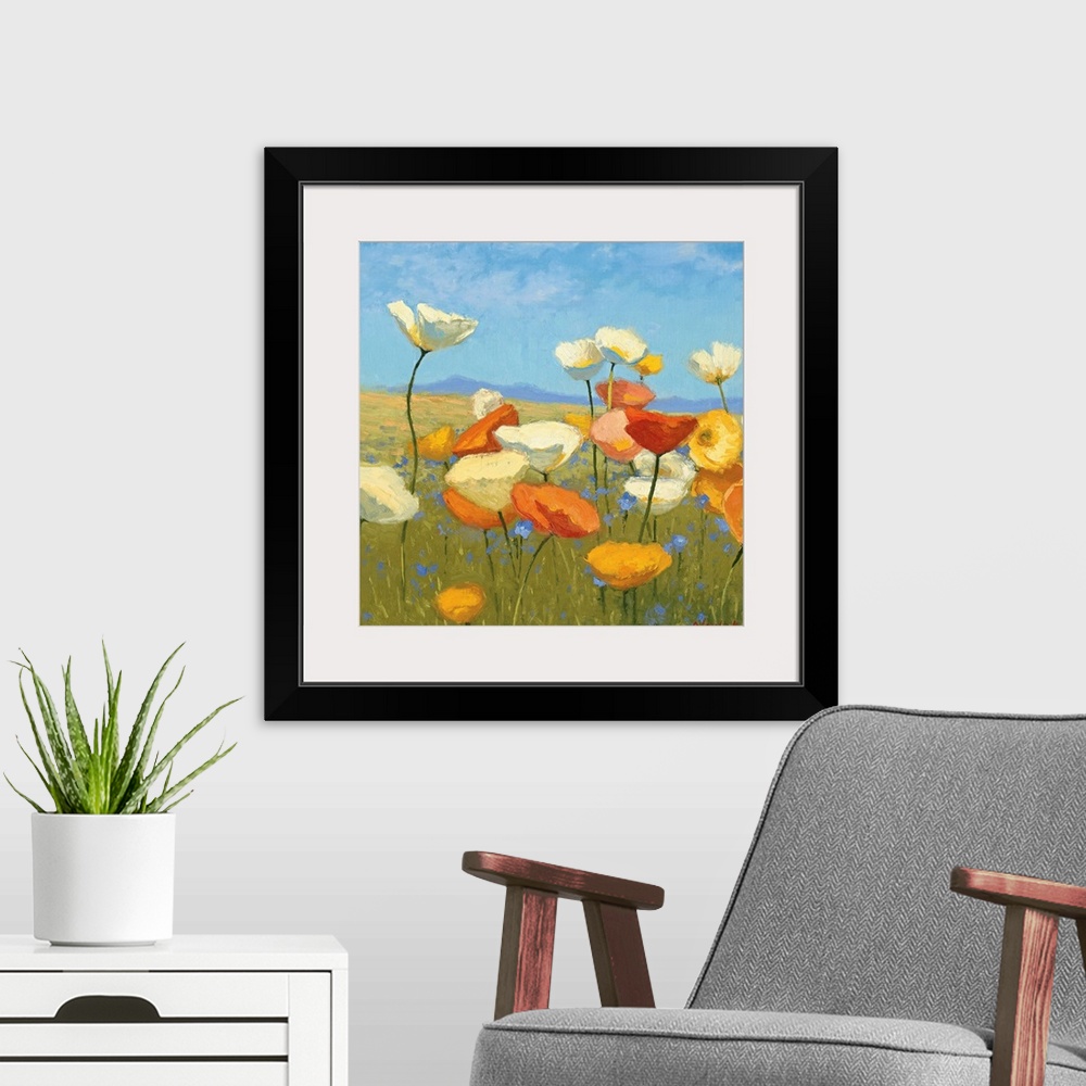 A modern room featuring Contemporary painting of flowers in a green field, with a blue sky above.