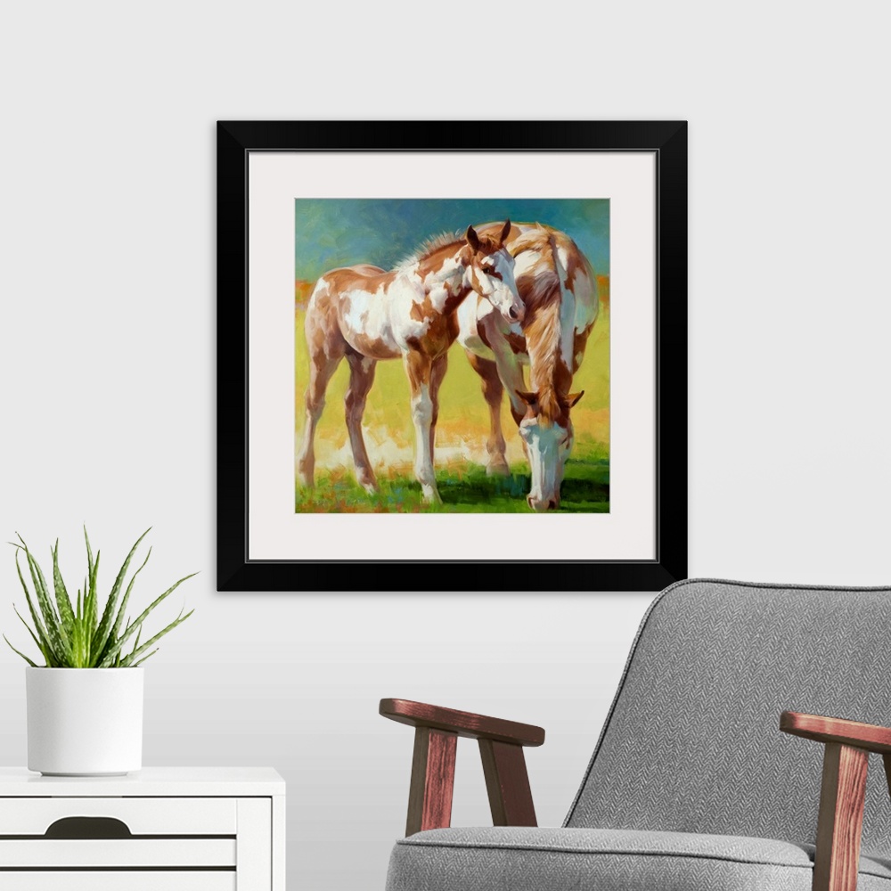 A modern room featuring A Paint mare and her foal grazing in a field in soft light.