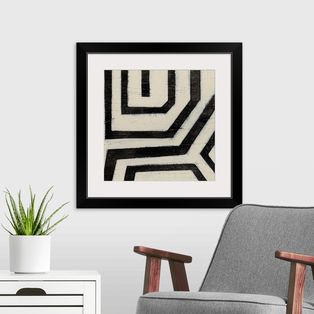 A modern room featuring Black and white abstract artwork made of angled lines.