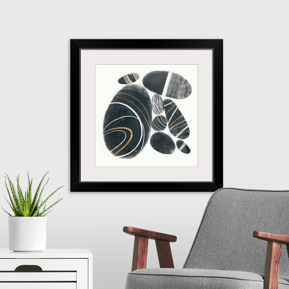 A modern room featuring Distressed dark gray circular shapes illustrate smooth stones that have been gathered together ag...