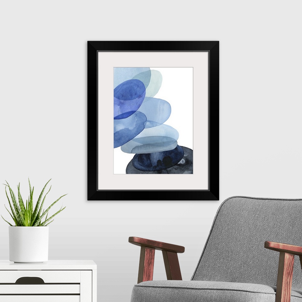 A modern room featuring Abstract watercolor painting of oval shapes, representing river stones, stacked on top of each ot...