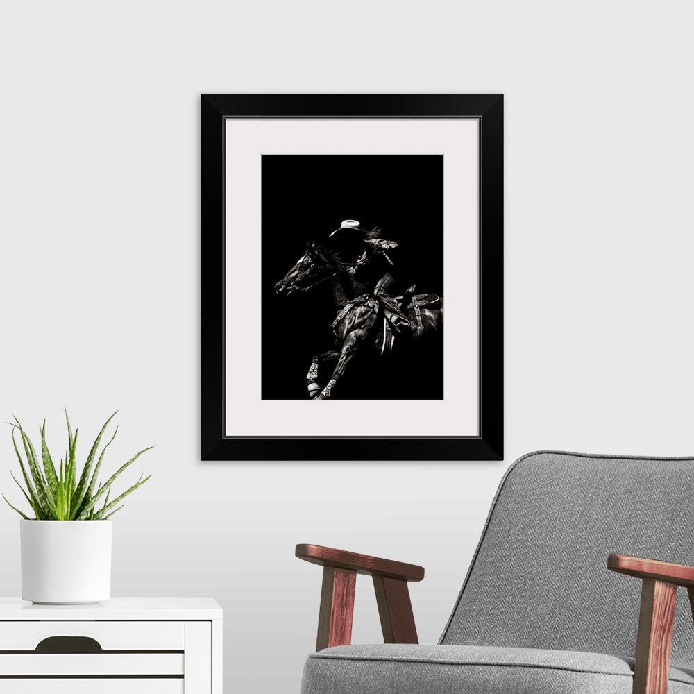 A modern room featuring Black and white lifelike illustration of a cowboy riding a horse.
