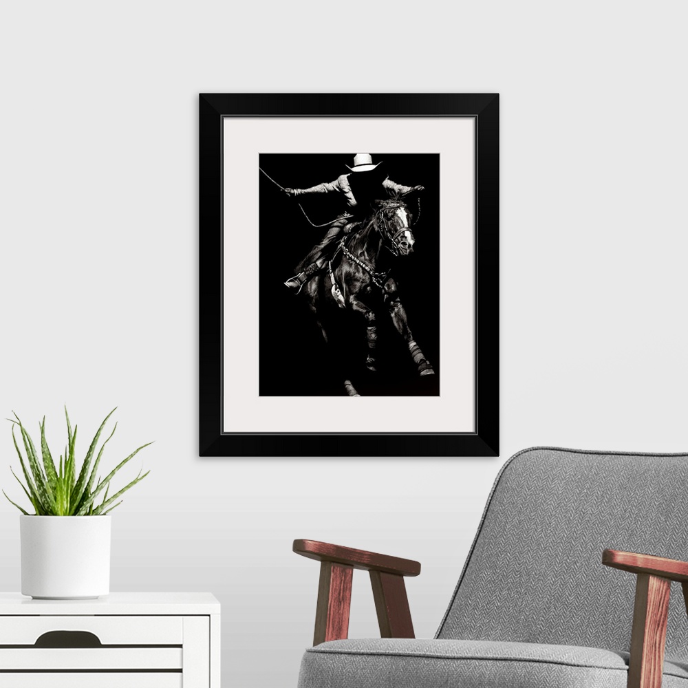A modern room featuring Black and white lifelike illustration of a cowboy riding a horse.