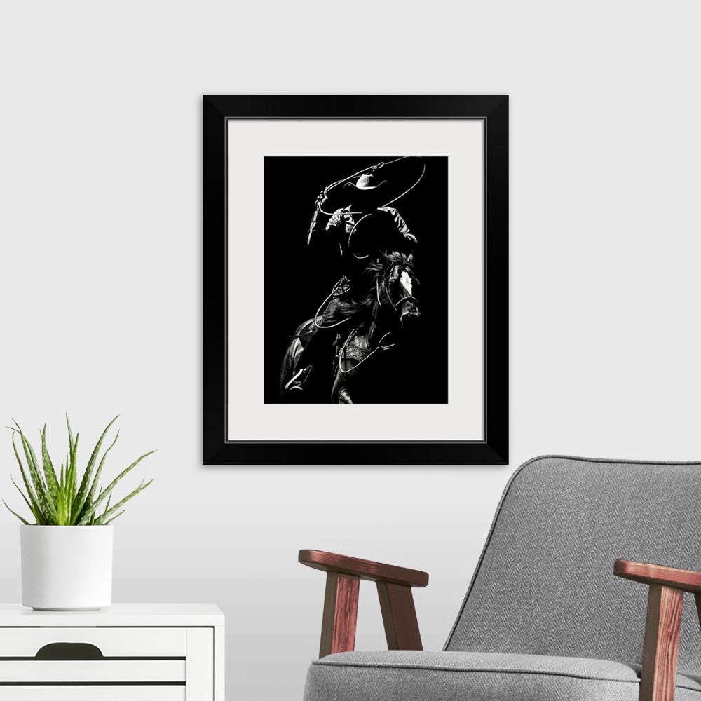 A modern room featuring Black and white lifelike illustration of a cowboy riding a horse with a lasso.
