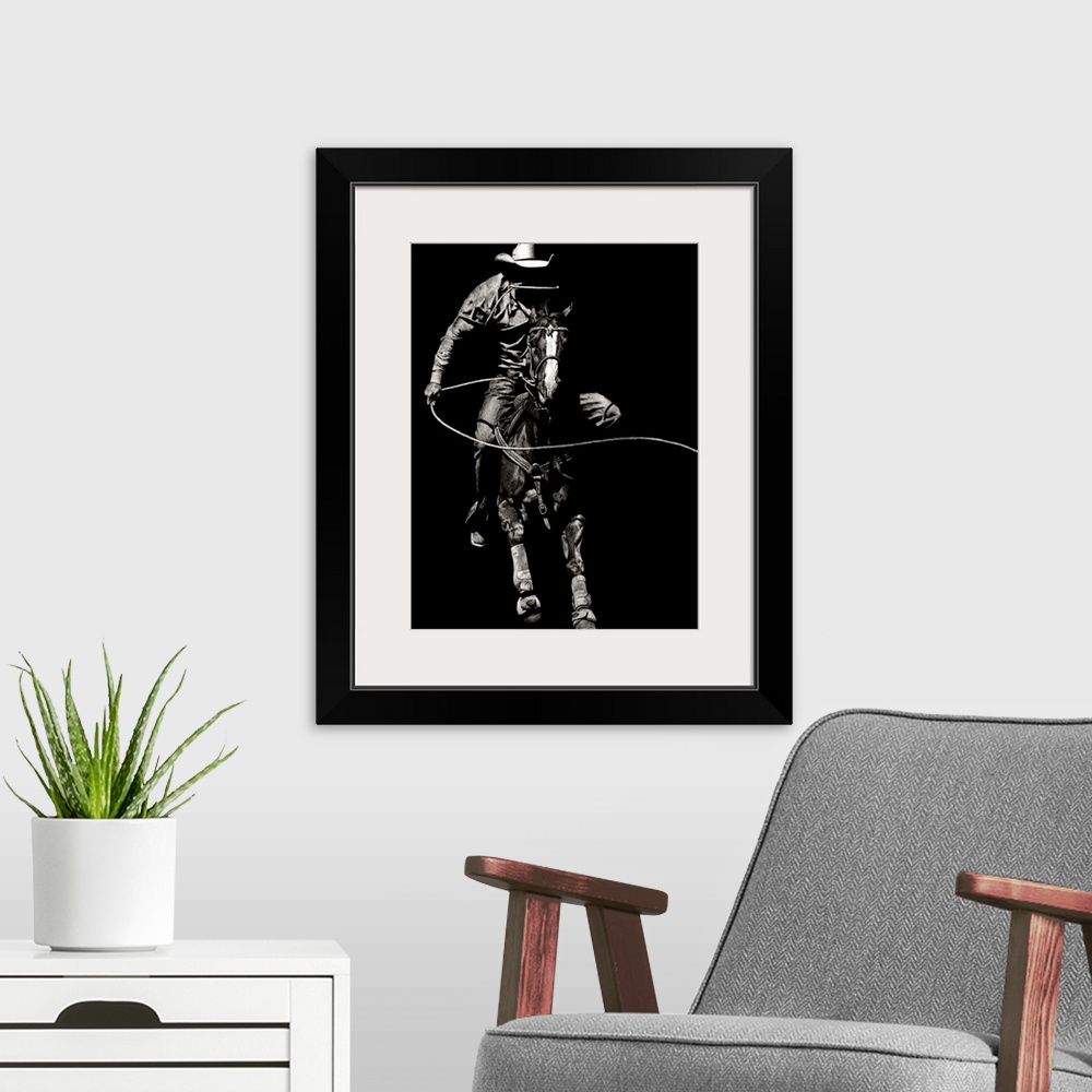 A modern room featuring Black and white lifelike illustration of a cowboy riding a horse with a lasso.
