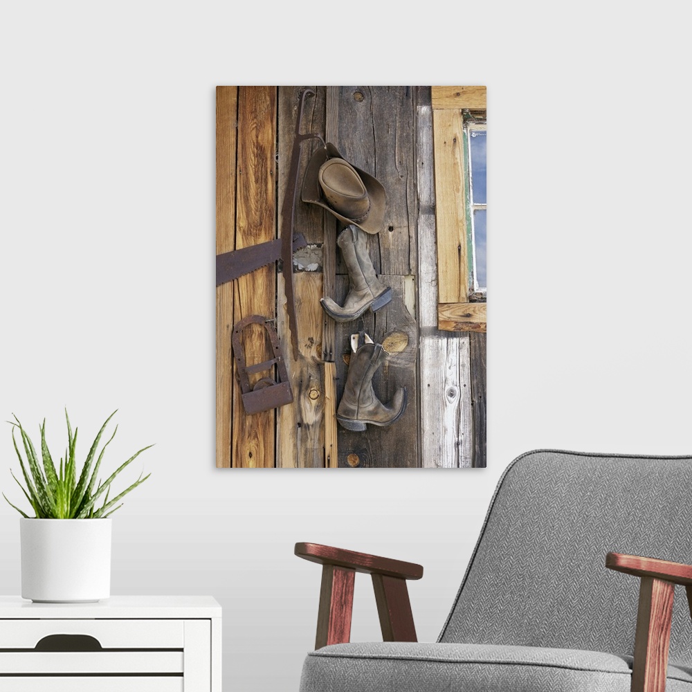 A modern room featuring Cowboy boots and hat hanging on cabin