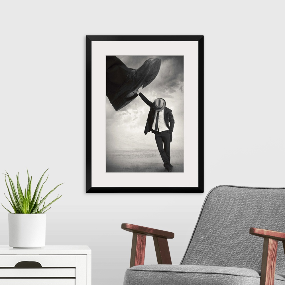 A modern room featuring An abstract art photograph of a man wearing a hat and suit, leaning against a giant foot trying t...