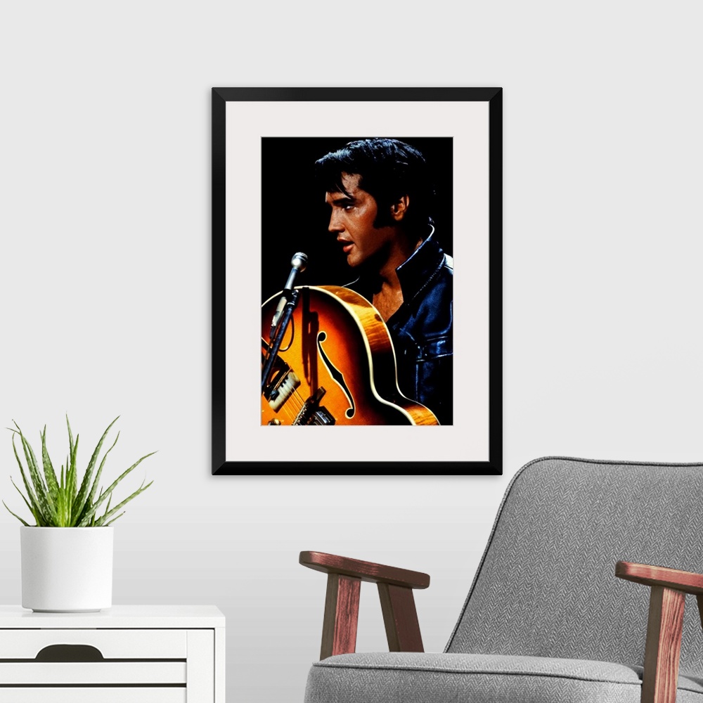 A modern room featuring Big canvas photo of an up close shot of Elvis Presley holding a guitar in front of a microphone.