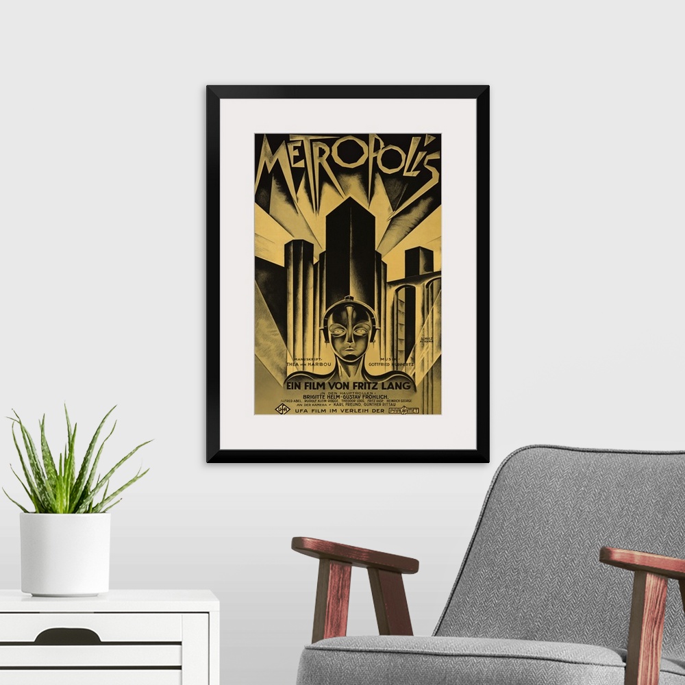 A modern room featuring Poster for the 1927 science fiction film Metropolis. Skyscrapers line the back of the poster with...