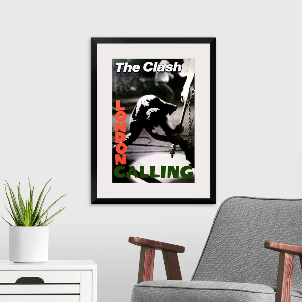 A modern room featuring Vertical, oversized black and white photograph of a band member of The Clash swinging a guitar to...