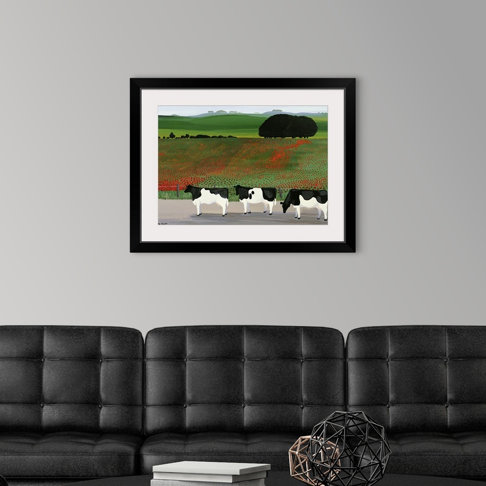 A modern room featuring Large artwork on a horizontal canvas of three cows standing in front of a fenced off field of pop...