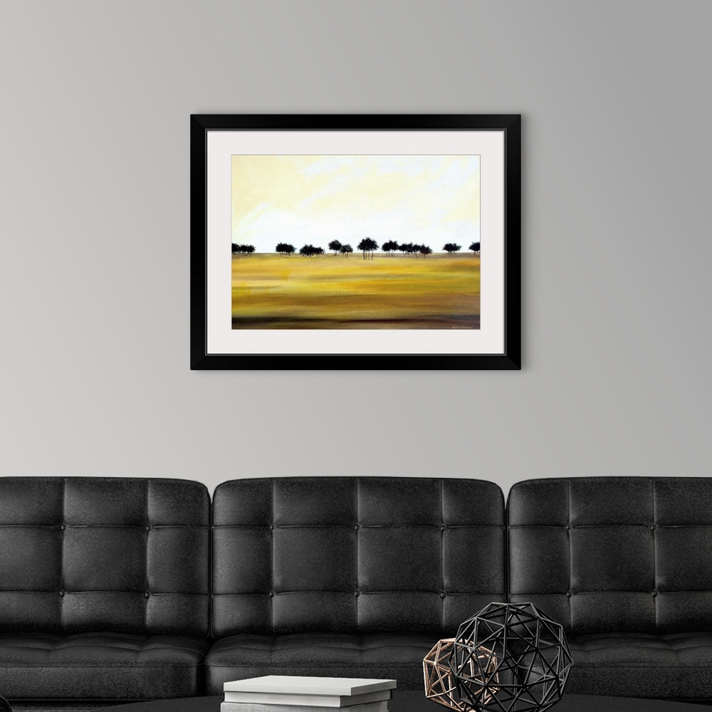 A modern room featuring Contemporary minimalist painting of a row of dark trees in the distance and golden fields in the ...