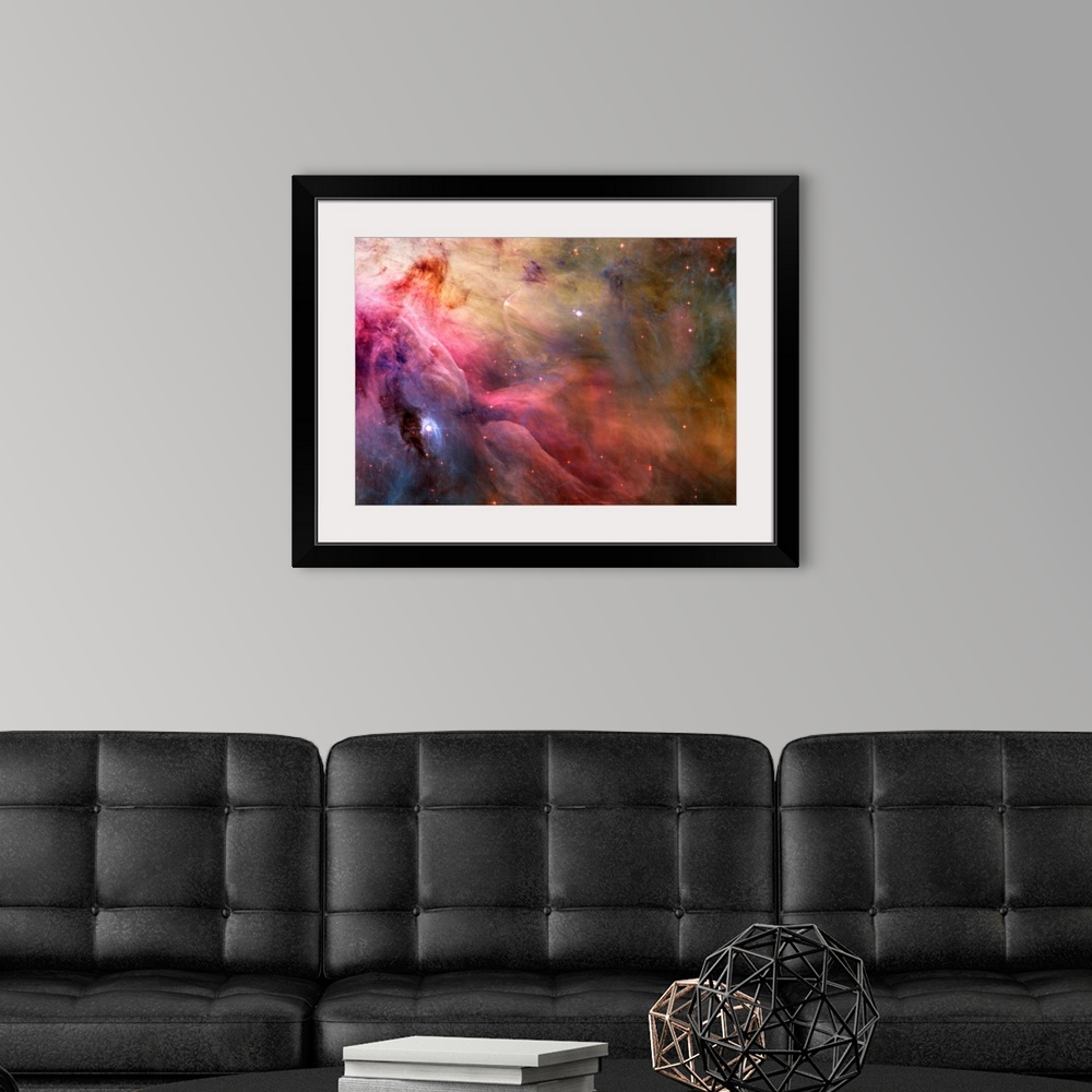 A modern room featuring Big canvas decor of a multicolored nebula with stars sprinkled around.