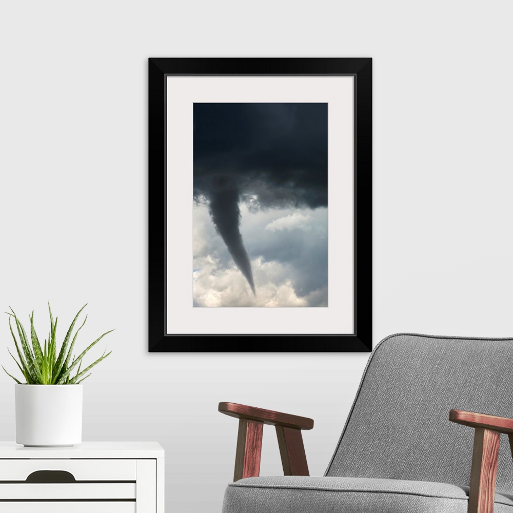 A modern room featuring Dramatic funnel cloud created in dark storm clouds. Calgary, Alberta, Canada.