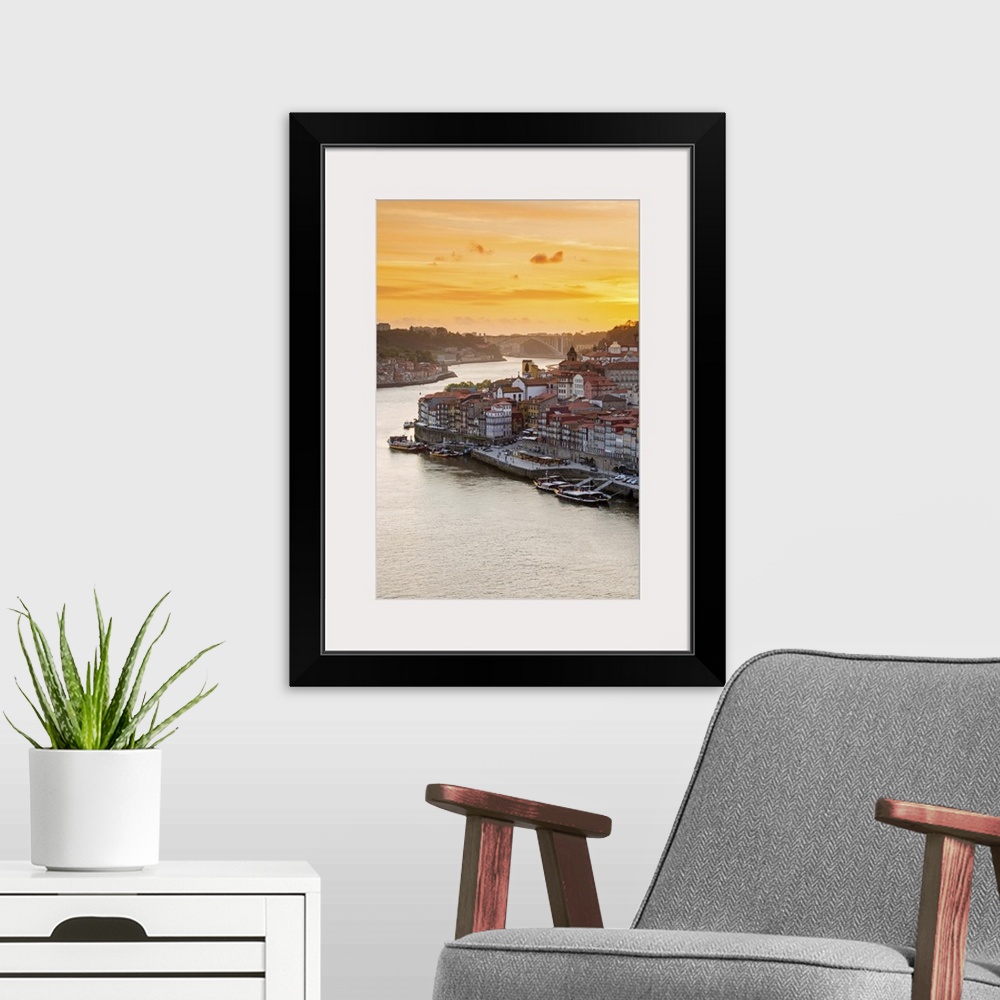 A modern room featuring Portugal, Douro Litoral, Porto. Sunset over the UNESCO listed Ribeira district, viewed from Dom L...