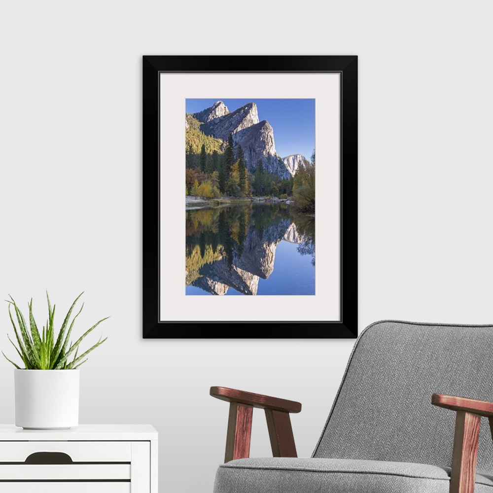 A modern room featuring The Three Brothers reflected in the Merced River at dawn, Yosemite Valley, California, USA. Autum...