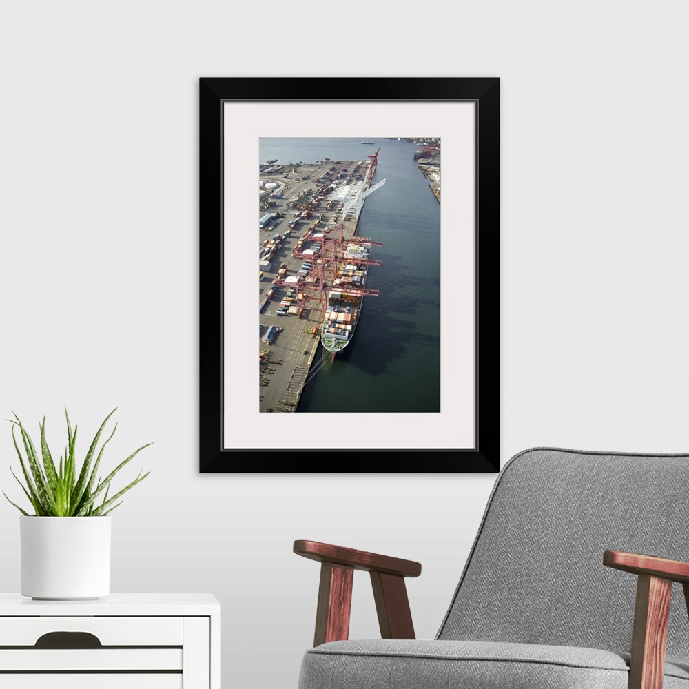 A modern room featuring Cranes loading a container ship at Port of Seattle, WA, USA - Aerial Photograph