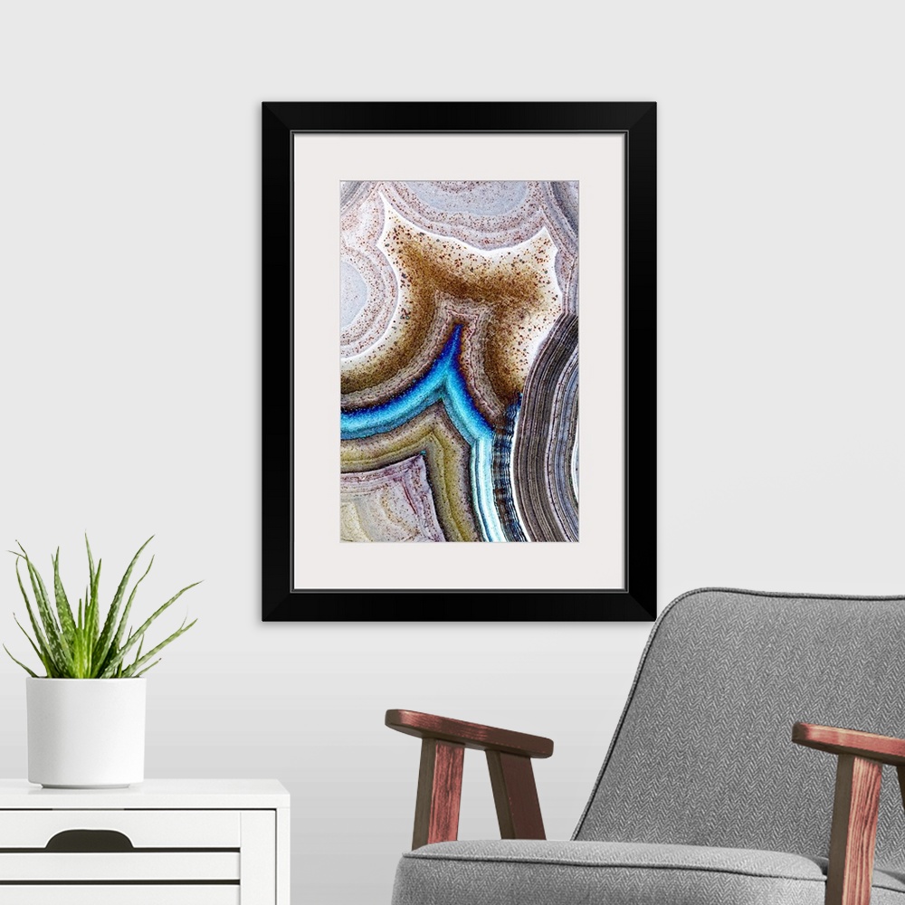 A modern room featuring Vertical macro photograph of details of geological elements layering to create rings of texture s...