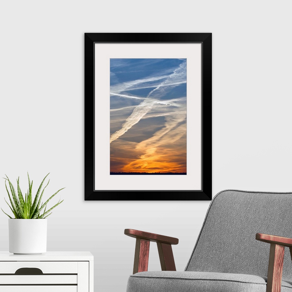 A modern room featuring Vapour Trails at sunset, from airliners, Germany