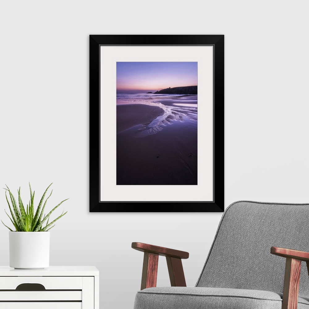 A modern room featuring Beach at sunset in Port Blanc area in Quiberon, pink an violet colors, France, a vertical view.