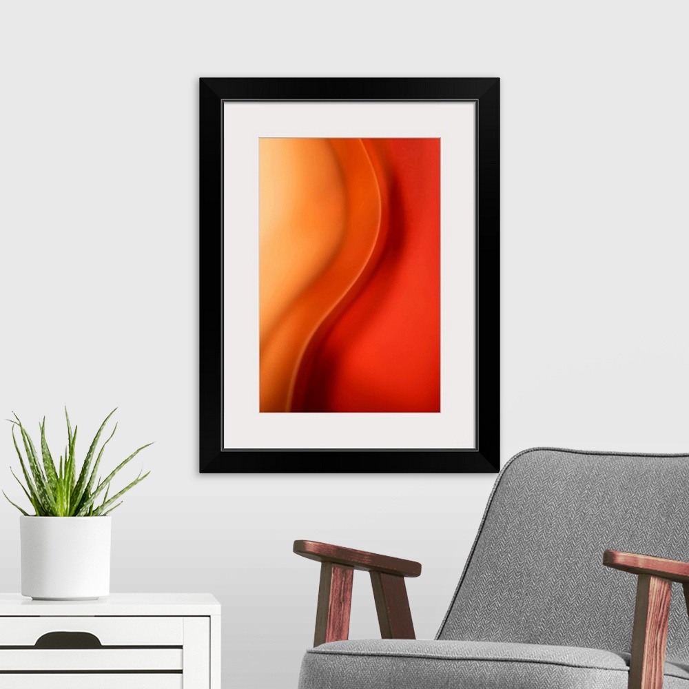 A modern room featuring Abstract artwork that uses warm colors throughout with a single wave down the middle.