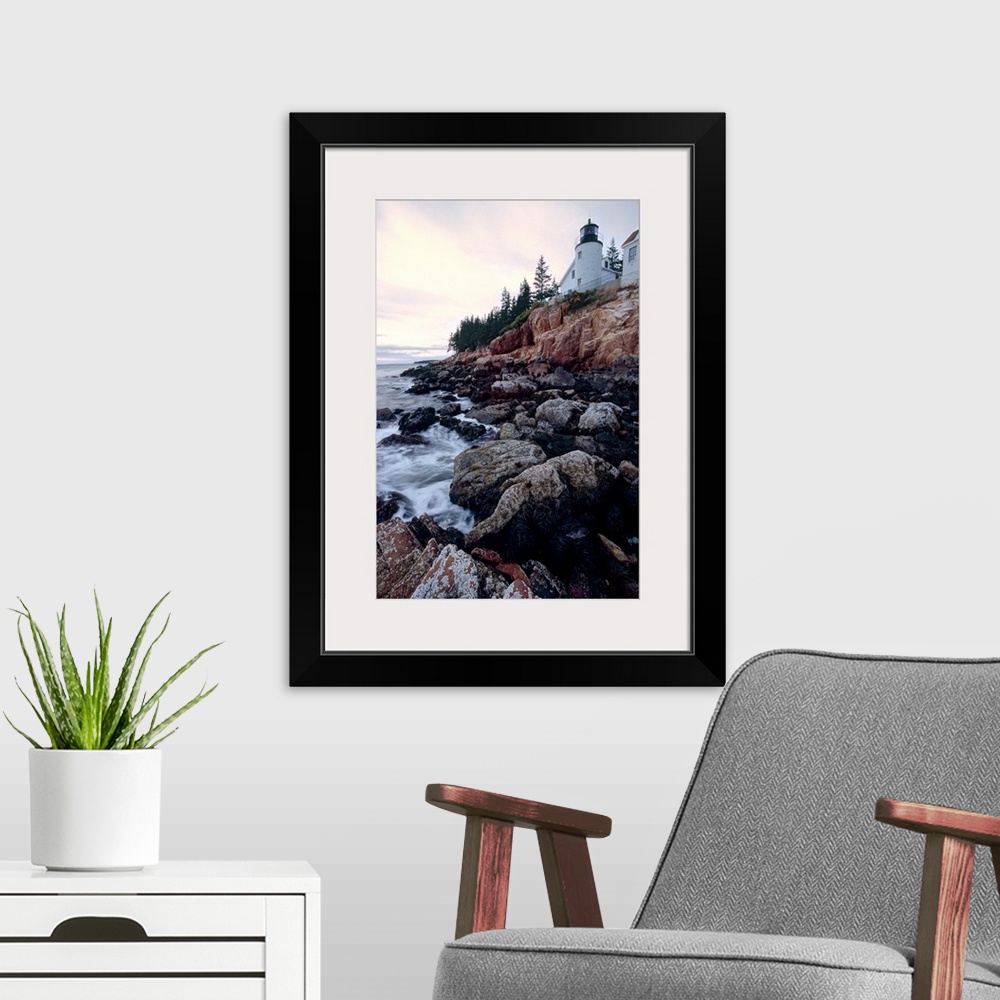 A modern room featuring Low angle view of the bass harbor head lighthouse that sits atop a rocky cliff.
