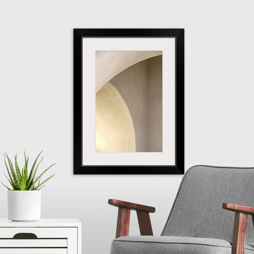 A modern room featuring Abstract photo of curved arches with white light.
