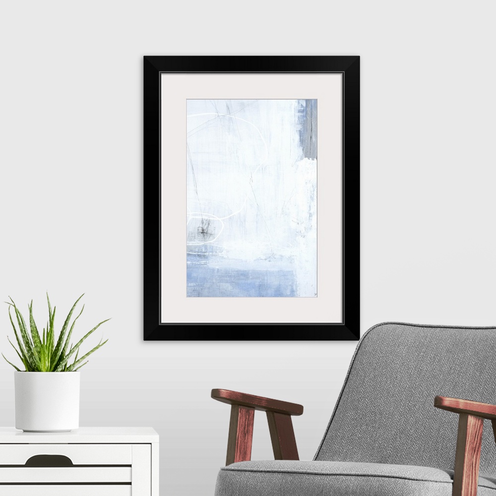 A modern room featuring A long vertical painting of washed colors of gray and blue with dripped paint textures and swirle...