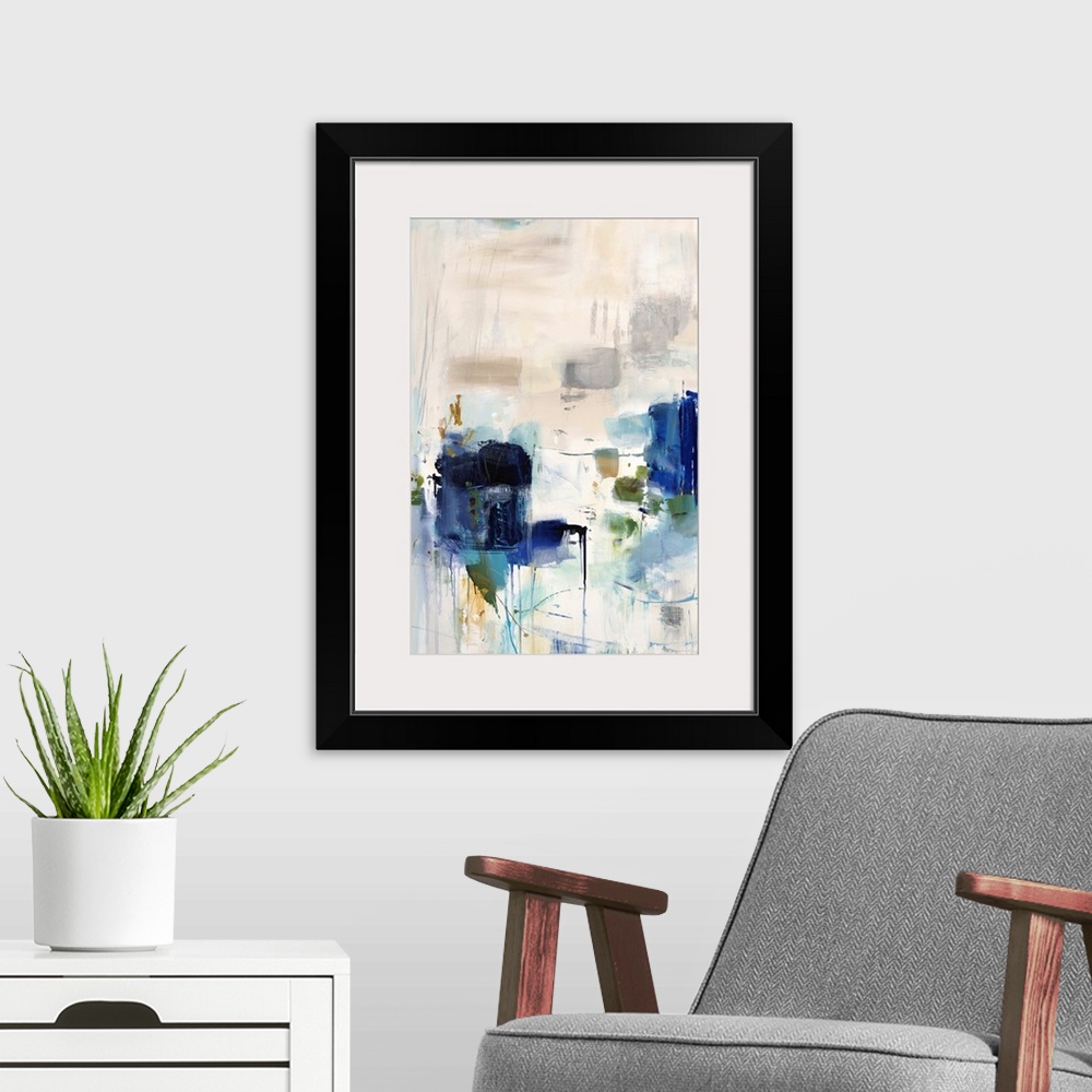 A modern room featuring Vertical abstract artwork with vivid squares of blue on white.