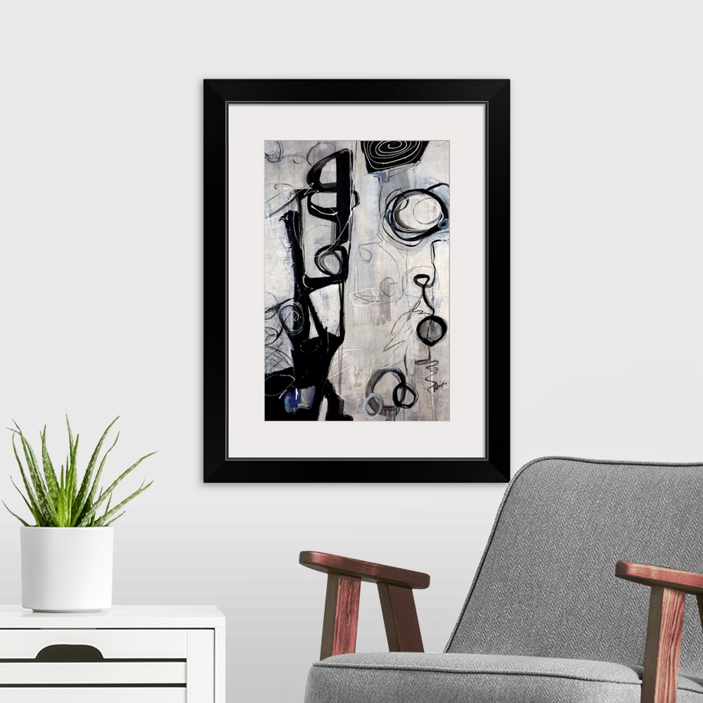 A modern room featuring Vertical oversized contemporary artwork of dark swirling circular shapes and scribbles on a strea...