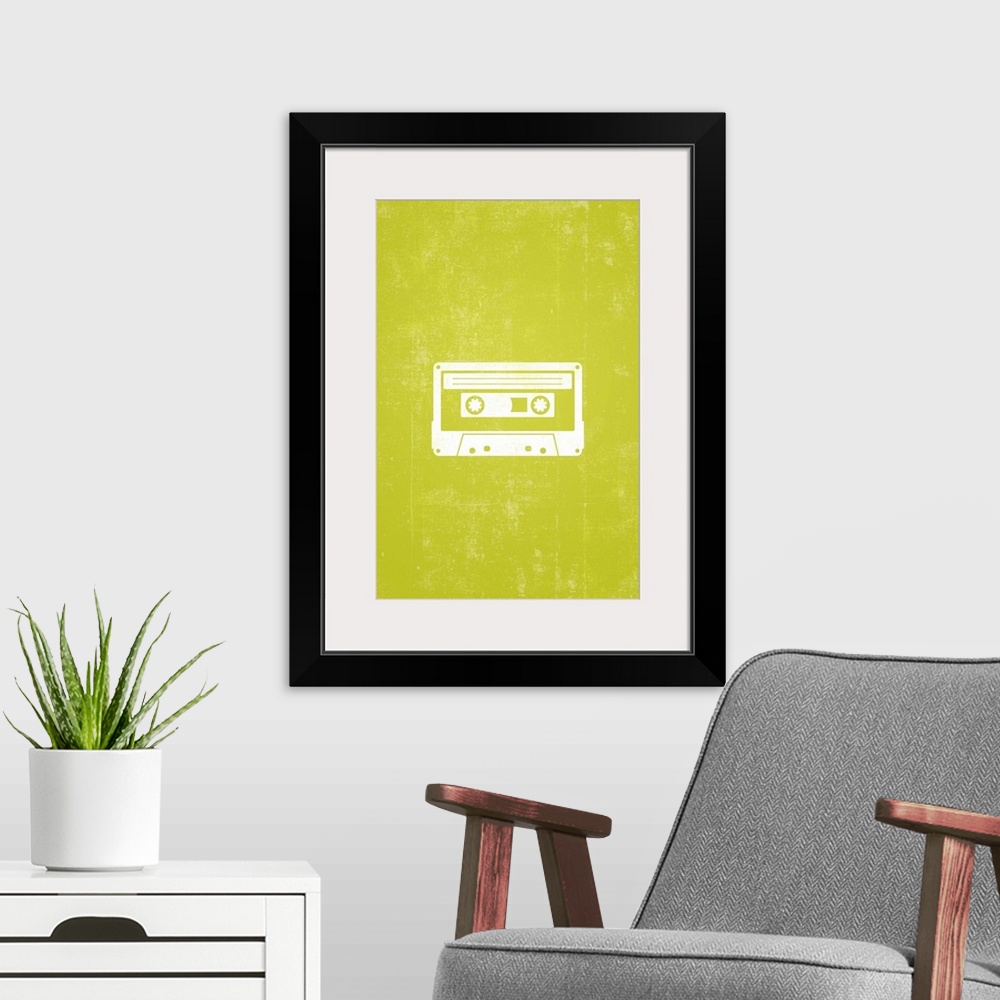 A modern room featuring Retro artwork that has a silhouette of a cassette tape against a neon green background.