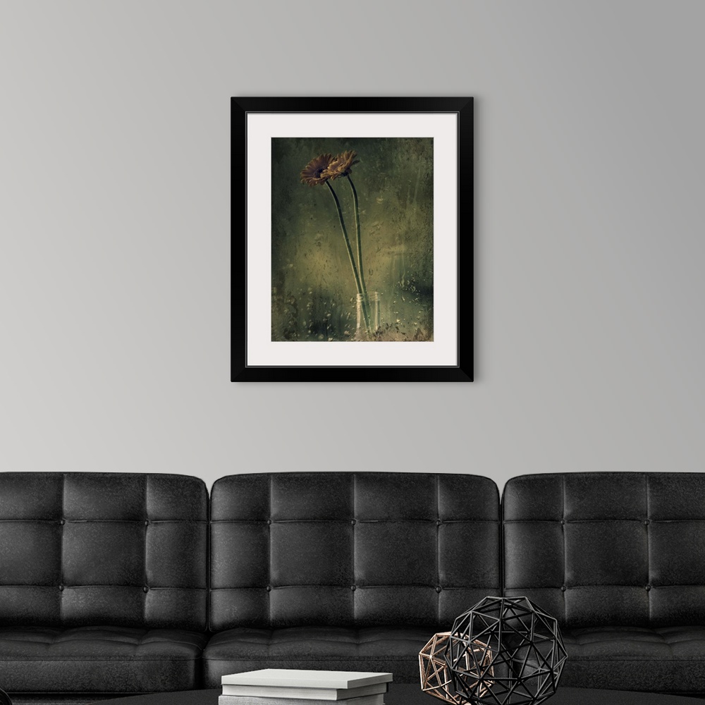 A modern room featuring Grungy photograph of long stem flowers in a small glass vase.