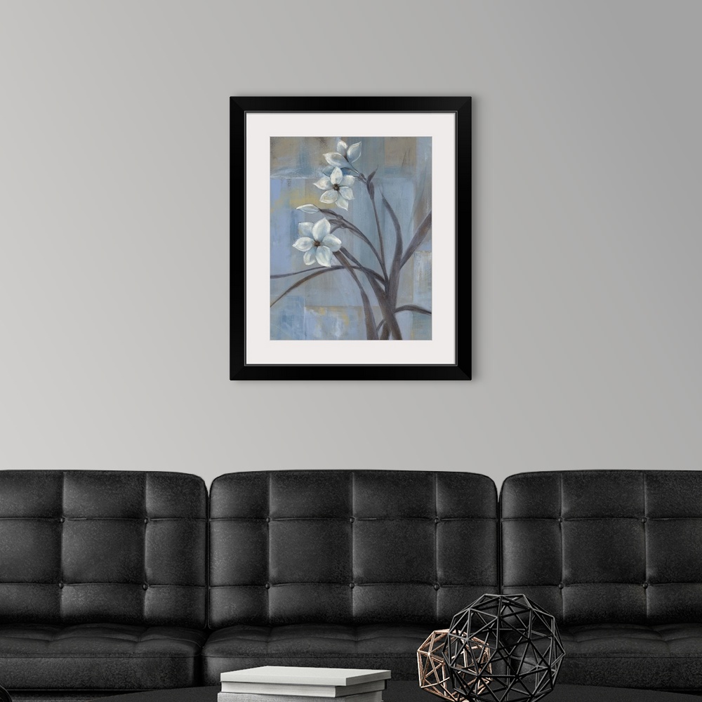 A modern room featuring Contemporary painting of three white tulips and slender leaves and stems.