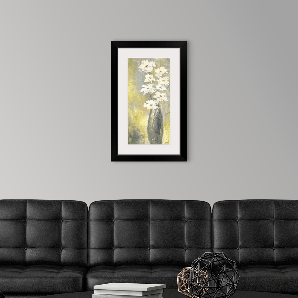 A modern room featuring Contemporary still life painting of white flowers in a thin vase.