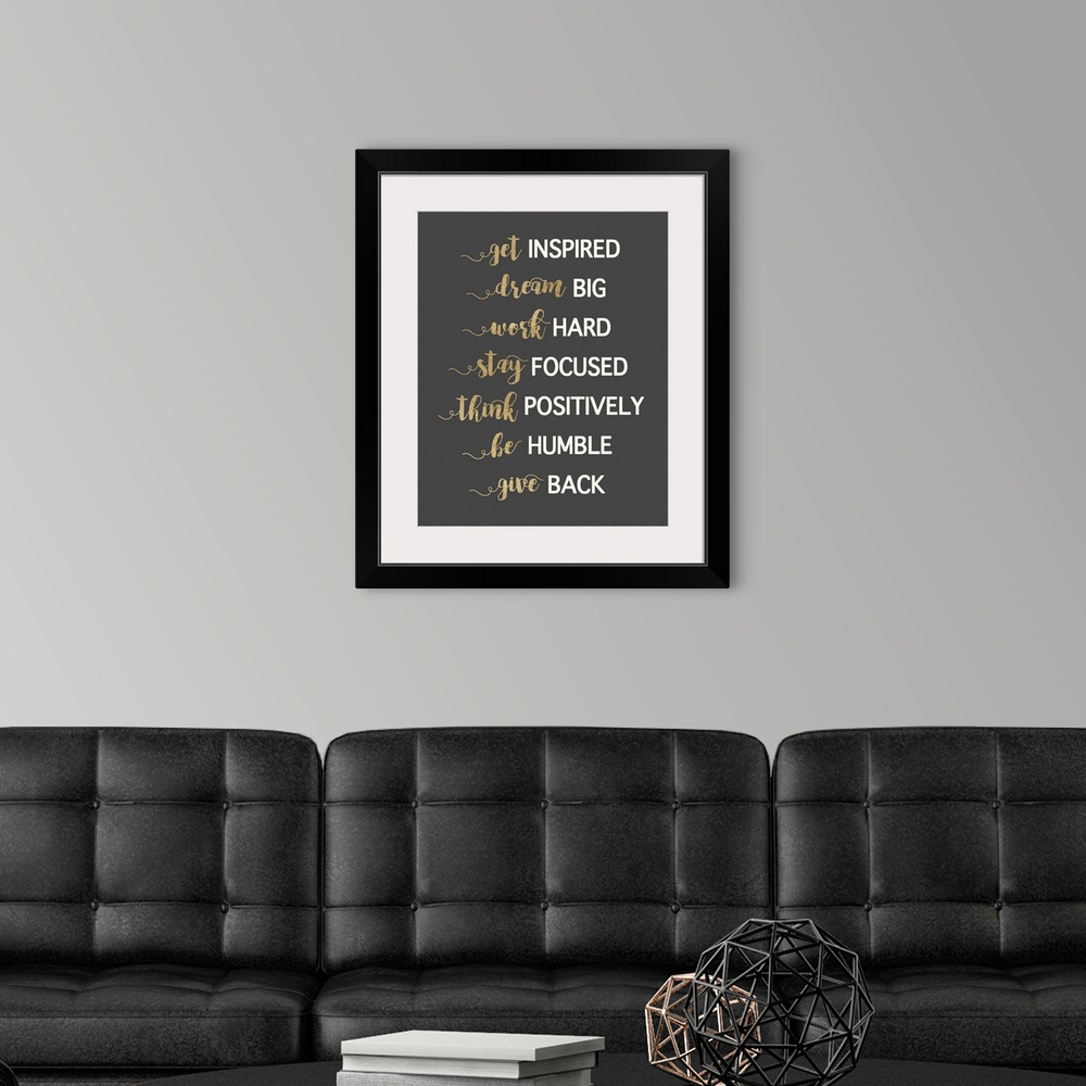 A modern room featuring Typography artwork in gold and white on dark grey of motivational phrases.