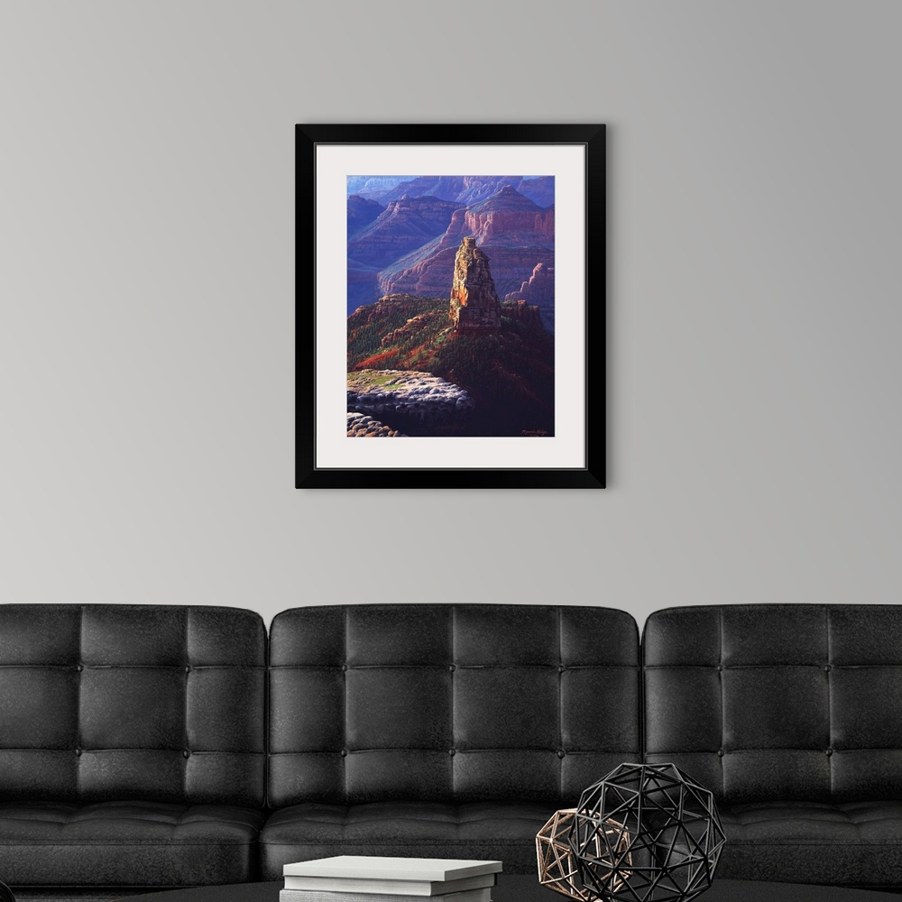 A modern room featuring A tall natural landmark stands against the backdrop of the canyon walls.