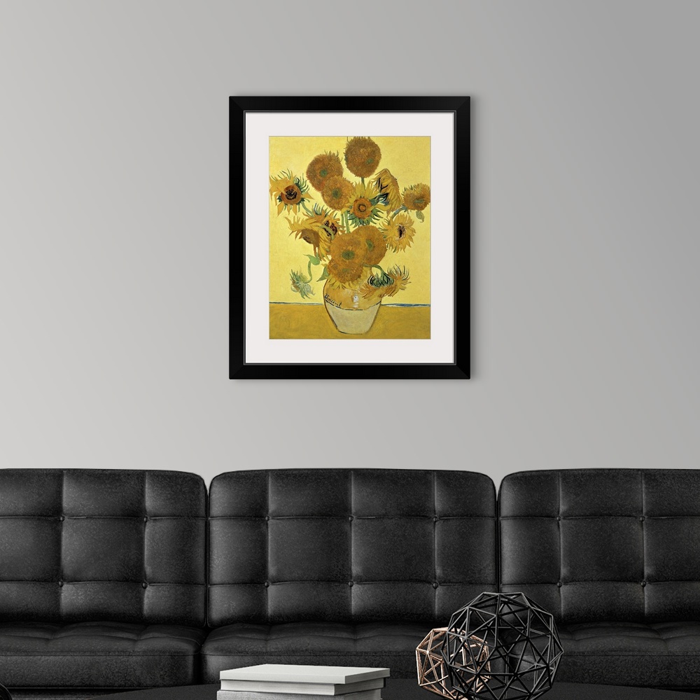 A modern room featuring Vincent Van Gogh's famous oil on canvas painting of sunflowers in a vase in warm tones.