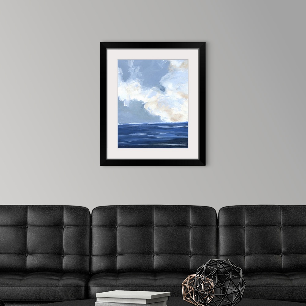A modern room featuring Contemporary painting of a calm ocean with large white clouds on the horizon.