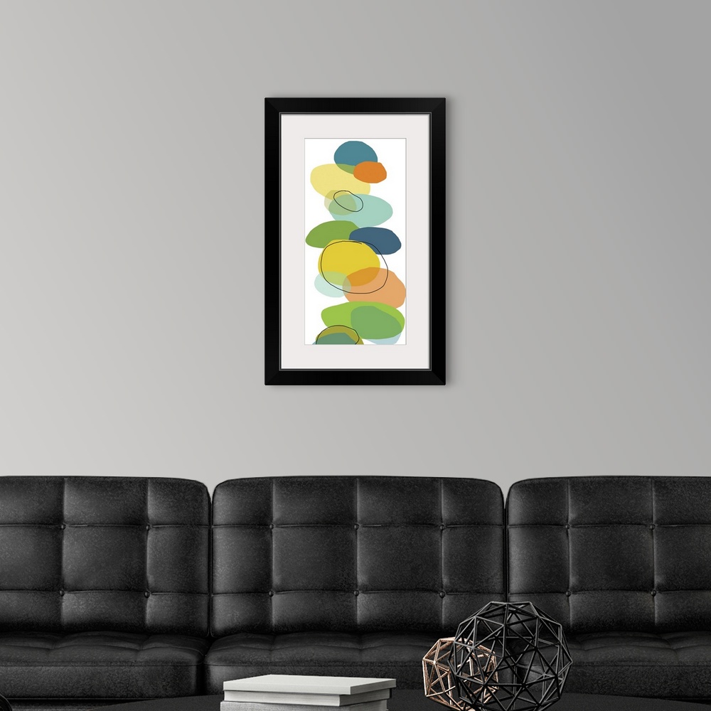 A modern room featuring Vertical, oversized contemporary artwork of multi-colored circular shapes resembling rocks that h...
