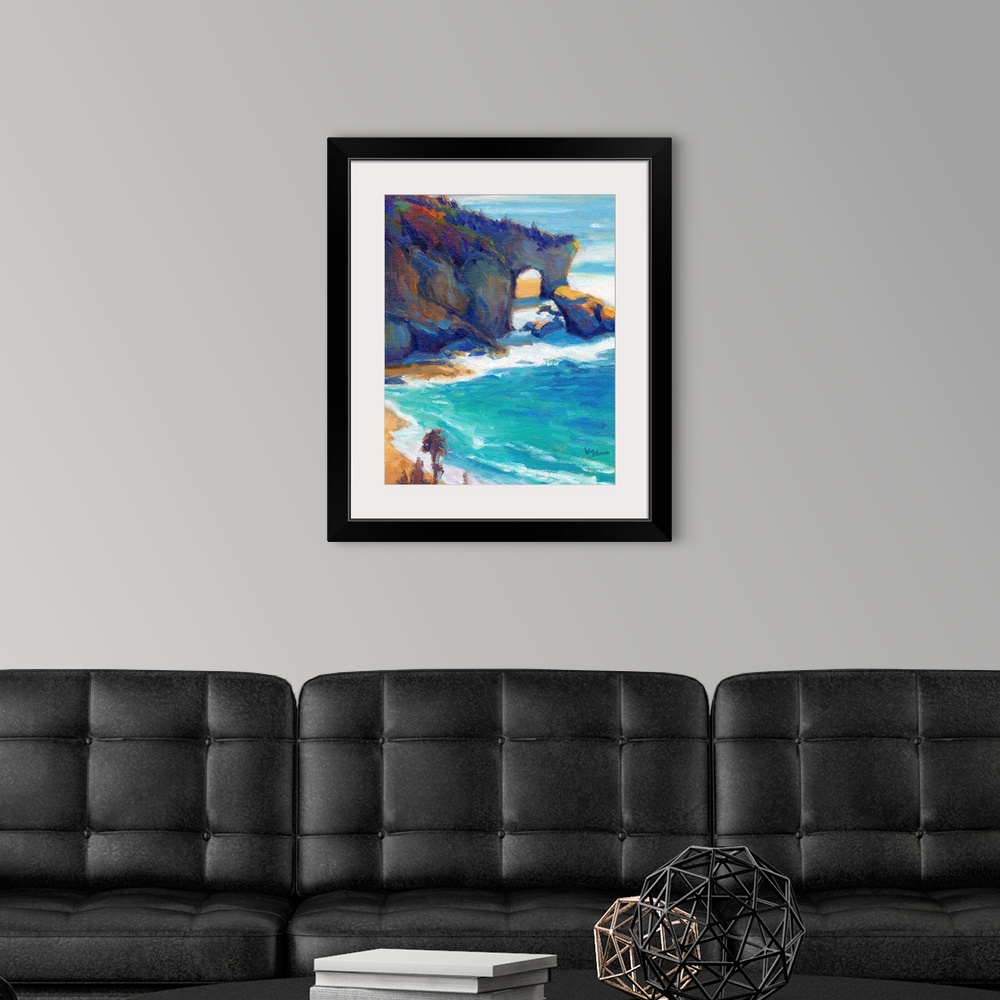 A modern room featuring Contemporary painting of a rocky cliff and a beach with vivid blue water.