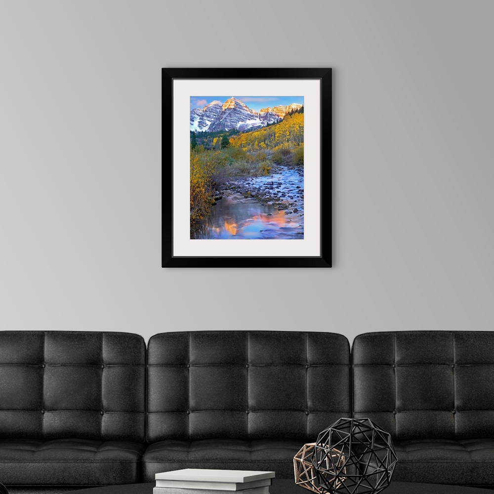 A modern room featuring Vertical wall art photograph of a rock filled stream running through an aspen tree filled meadow ...
