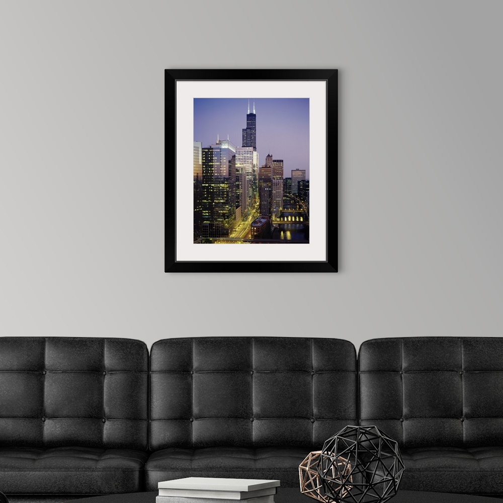 A modern room featuring Vertical photograph of several towering buildings in the urban city of Chicago at twilight.
