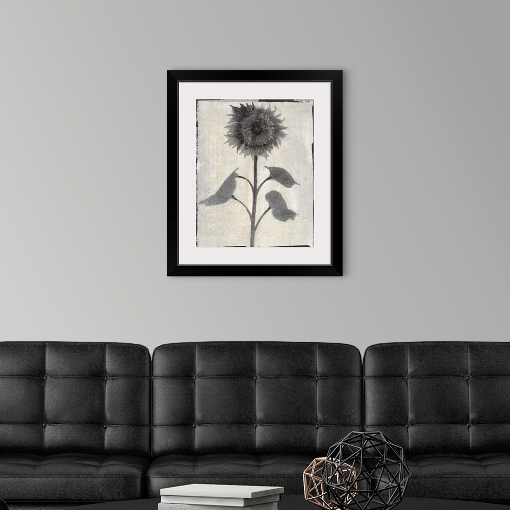 A modern room featuring Vertical contemporary painting of flowers in faded shades of grey with a rough, simple black border.