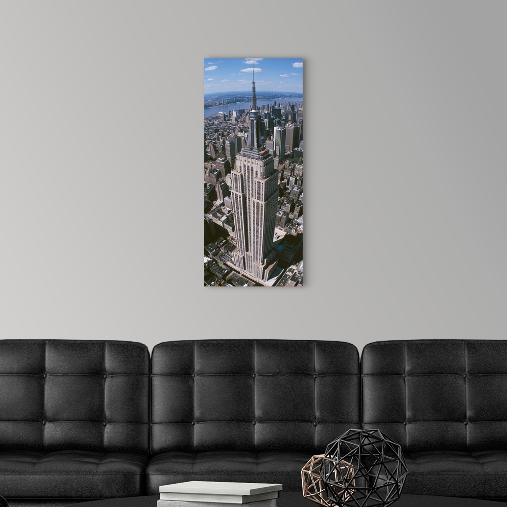 A modern room featuring Panoramic photograph taken from an aerial view focuses on a landmark skyscraper found within Manh...